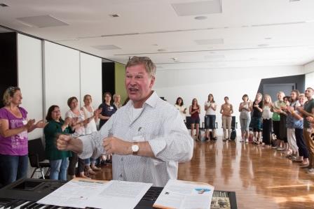 Referent und Liedermacher Reinhard Horn singt mit den Workshop-Teilnehmer/innen.
